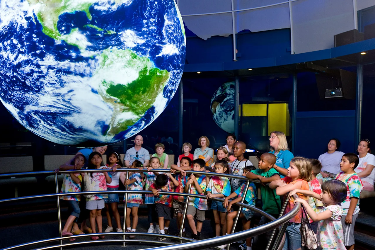 A Science On a Sphere installation — NOAA's six-foot suspended globe lit with planetary data in a museum exhibit space